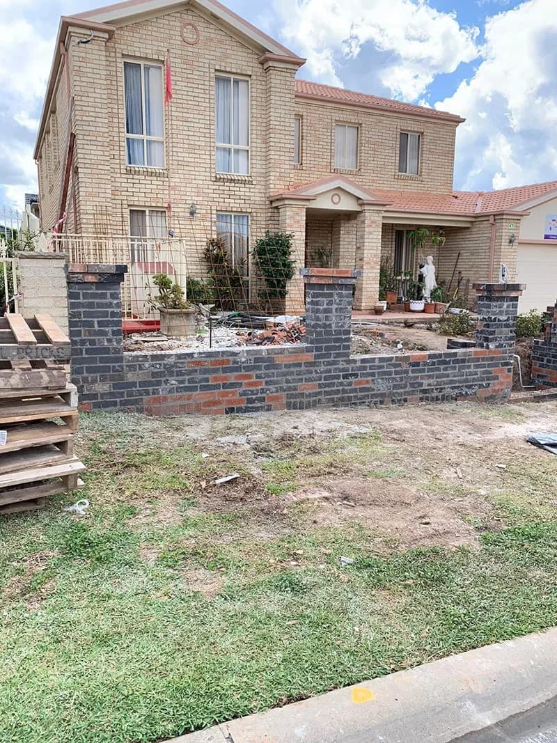 Low boundary brick wall and piers under construction