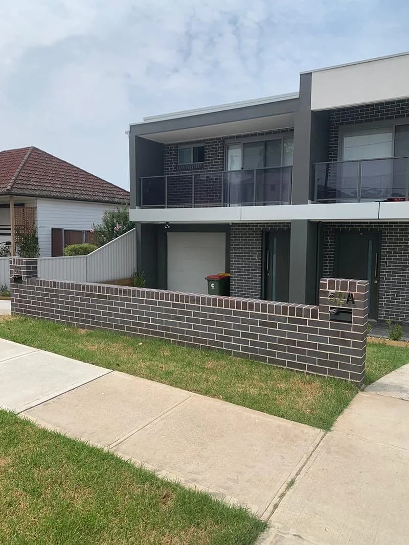Duplex low brick front fence lawn