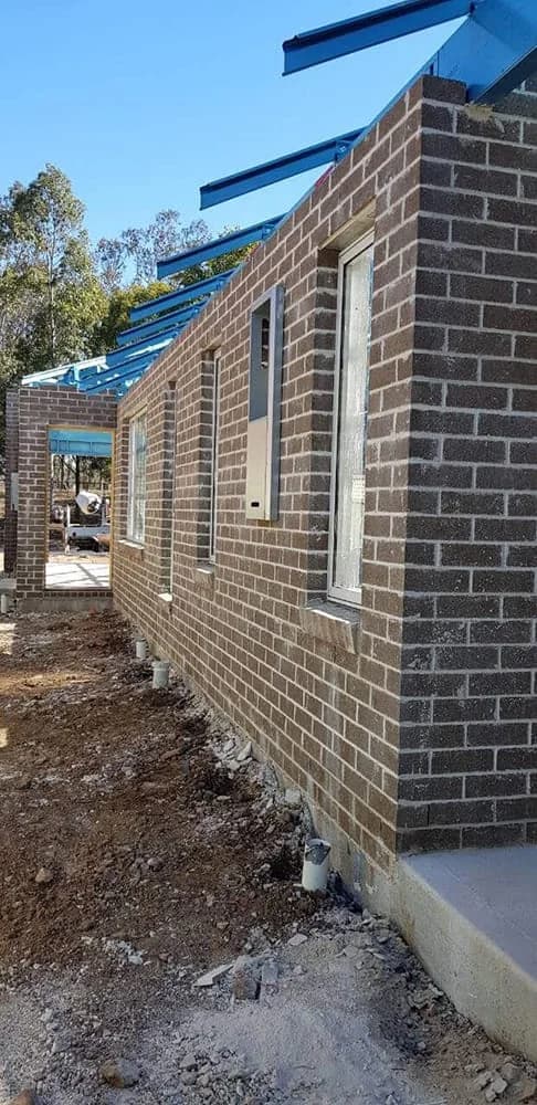 Long brown brick side wall