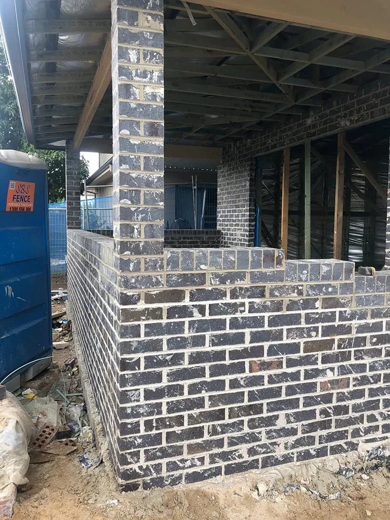 Existing brickwork with visible mortar variation beside an opening